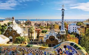 A vibrant collage featuring landmarks from Barcelona and Madrid, Spain, including the Sagrada Família, Park Güell, and the Royal Palace. The image highlights the rich cultural and architectural diversity of these two iconic Spanish cities.